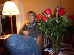 Alice sitting by the flowers sent by her friends at Performing Arts Lodge.