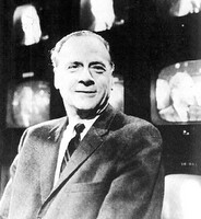 Black and White image of Marshall McLuhan in front of TV screens